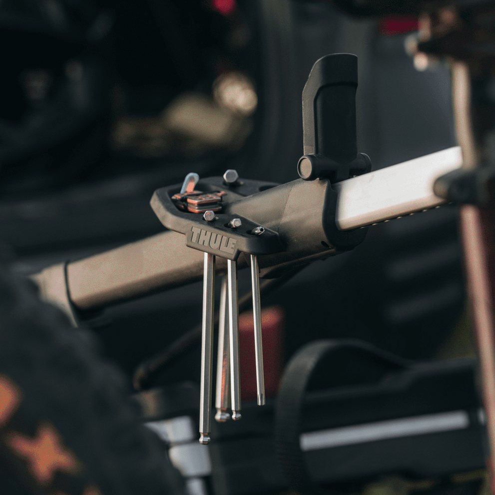 A close-up of a Thule Epos Bike Repair Holder mounted on a Thule Epos bike carrier